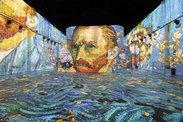 Van gogh face in blue immersive exhibition room